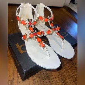 Bebe Dayna flat sandals in white with orange and pink tone jewel work.